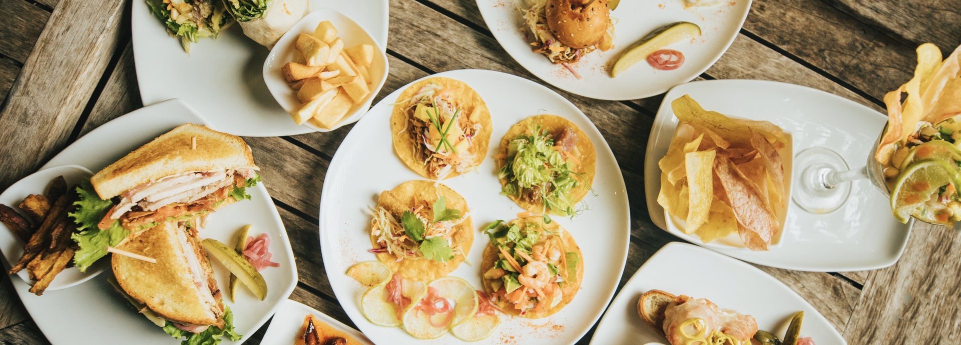 A spread of Surf Club dishes on the deck — plates, sharing boards and sides.